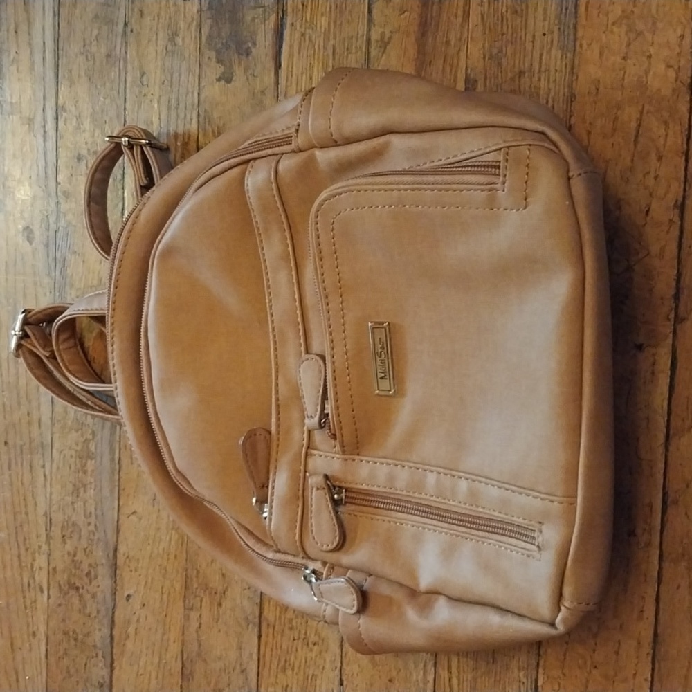 Multisac tan backpack purse. Has several zippers and pockets